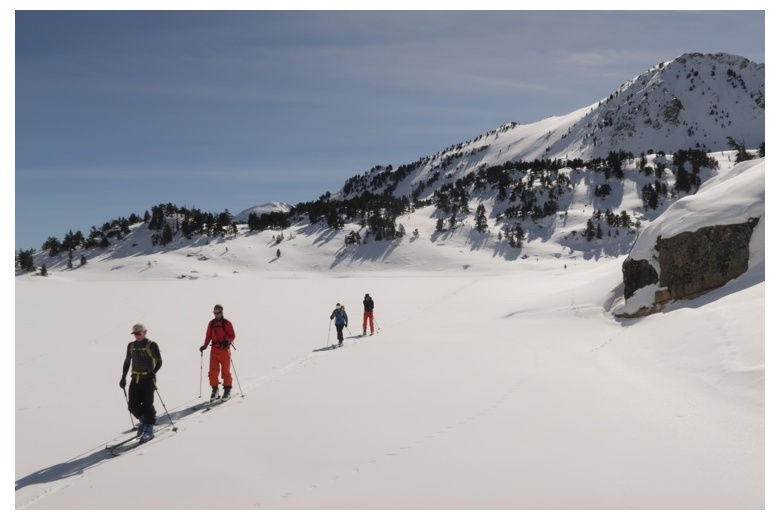 skieurs en randonnée traversant un lac gelé