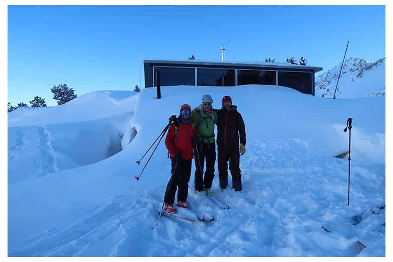 group of skiers outside saboredo hut right before starting the route of the day