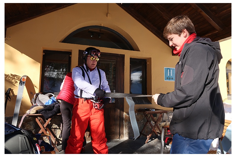 touring skiers getting ready for the day outside hotel banhs de tredòs