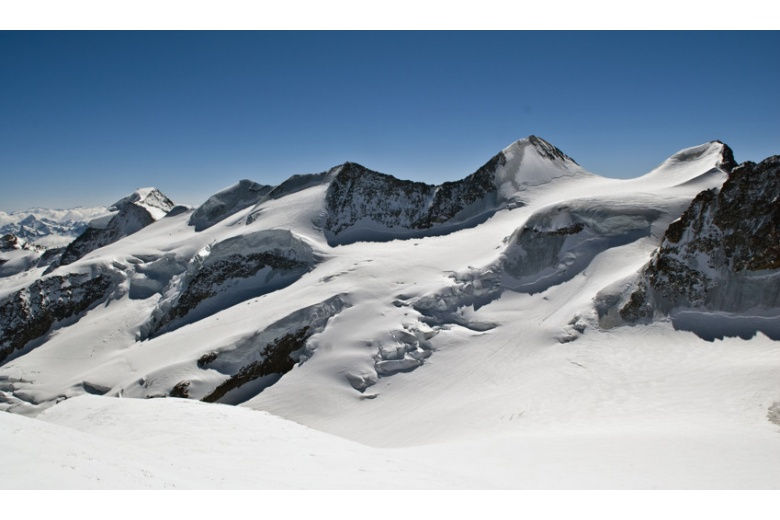 panoramic view of several mountain peaks  covered by snow, plus impressive seracs
