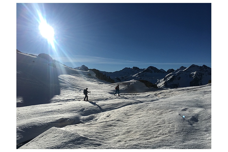 esquiadores ascendiendo el garmo negro en la majada alta de las argualas en día soleado de primavera